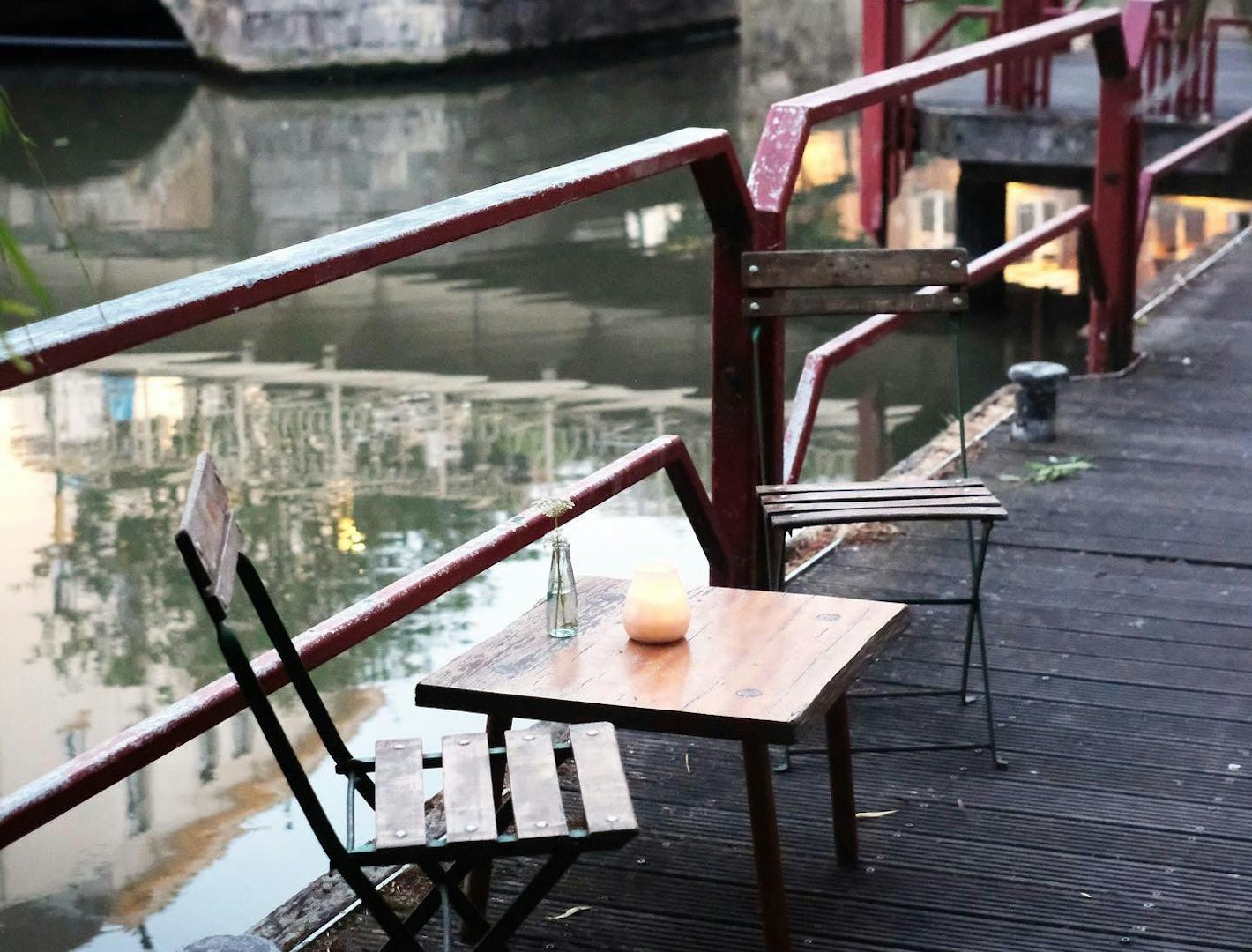 tables by the water at Jigger's cocktail bar